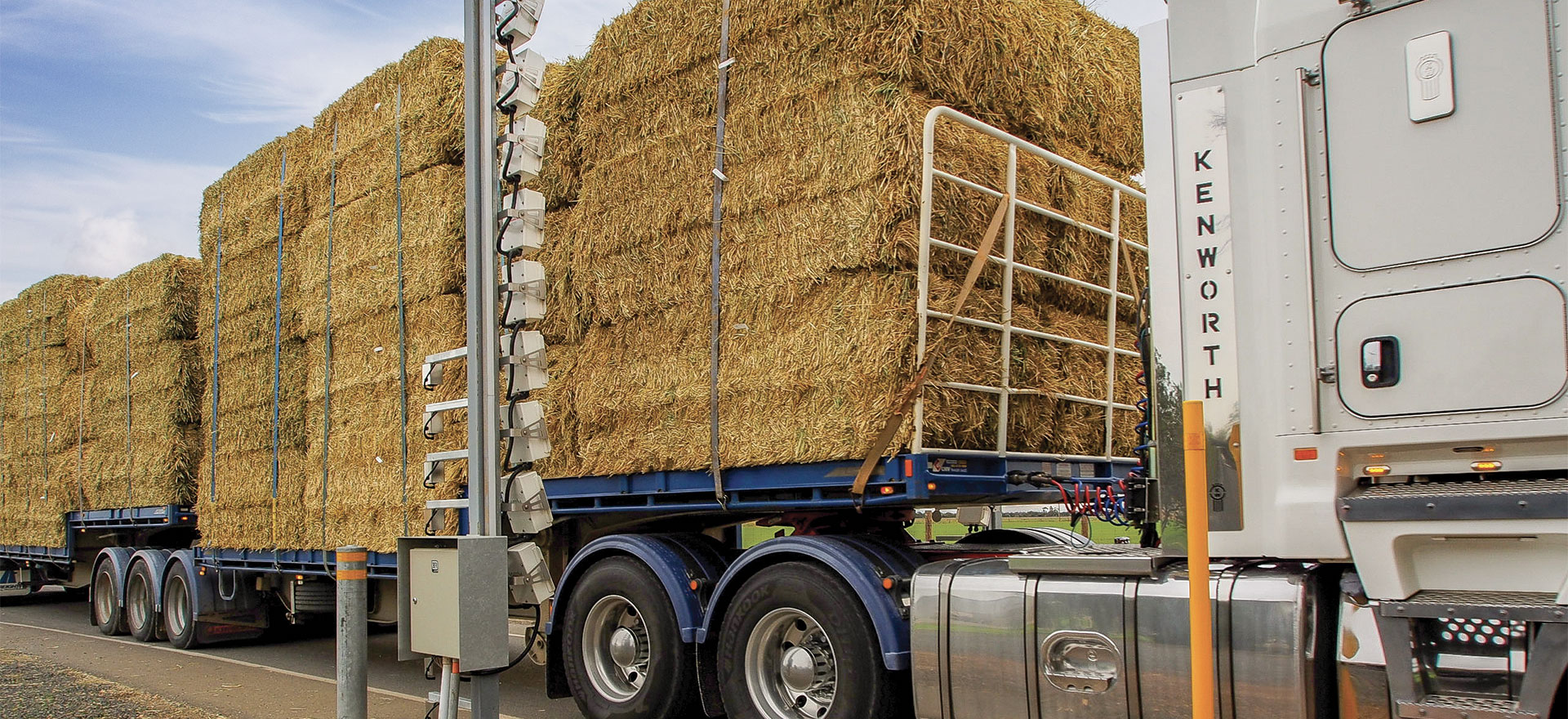 Truck load of big square hay bales passing through a Gazarray 916 bulk hay moisture gauge